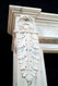 Elongated acanthus leaf design extends down the leg of the Auguste marble mantel.