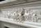 Acanthus Leaf and berries adorn the elongated center spray on this cararra marble mantel