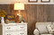 Rustic wood paneling in tall wainscoting height gives a shabby chic style to this room makeover