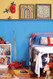 A boy's bedroom featuring beaded birch paneling, painted blue