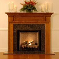 There is dentil molding and decorative trim molding on this mantel