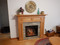 Savannah custom mantel in red oak stained with an electric fireplace.