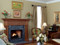 The Princeville custom fireplace mantel has smooth column legs that sit on a square base