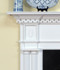 Molding neatly frames our sunburst appliques above the legs and in the center of the breast plate of this Colonial Fireplace Mantel.