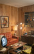 The coloration of the Natural Birch is a rich, warm golden-brown with medium undertones. It has a soft satin or semi-gloss finish that catches the warm, ambient light from the lamps without being overly reflective.