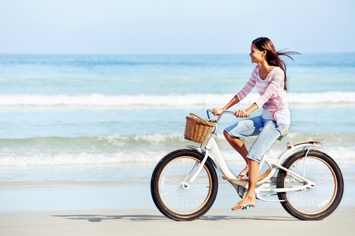 Girl Riding Bicycle on Beach