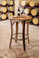 ustic wine barrel bistro table made from reclaimed oak barrel staves with galvanized steel rim and footrest, perfect for wineries, home bars, patios, and tasting rooms.