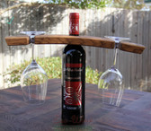 Wine bottle holder made from a single Stave with two glass holders. Wine and glasses not included.