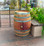 "Authentic reclaimed oak wine barrel with metal hoops, stamped with Napa Valley logo. Perfect for home décor, garden planters, rustic bars, and DIY furniture projects."