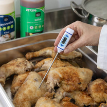Slim thermometer digital screen showing temperature reading of hot food