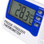 Close up of digital thermometer showing control buttons and display reading