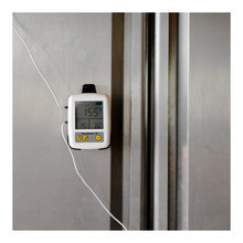 Thermometer mounted on a fridge shelf with dual probes monitoring fridge compartments