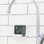 TimeWash timer mounted near sink, ready for touch-free use