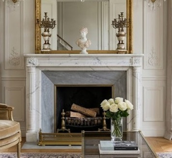 This bright, symmetrical drawing room offers an immaculate, upscale backdrop for the elegant white Versailles marble mantel. Grounded in the clean lines and understated ornamentation of the Louis XVI period, the space beautifully balances architectural rectitude with inviting luxury.