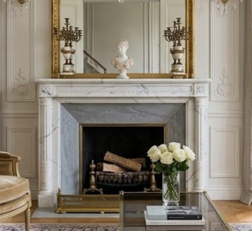 This bright, symmetrical drawing room offers an immaculate, upscale backdrop for the elegant white Versailles marble mantel. Grounded in the clean lines and understated ornamentation of the Louis XVI period, the space beautifully balances architectural rectitude with inviting luxury.