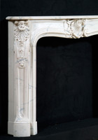 Corner acanthus leaves in fine detail on this Louis XIV marble fireplace mantel surround