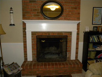 Monticello fireplace mantel installed on brick.