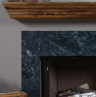 The wooden shelf compliments the marble surround.