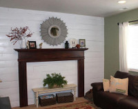 This homeowner created a fireplace feel where they didn't have one, by using a mantel by itself