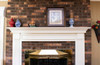 Leesburg mantel installed on brick wall around a fireplace insert