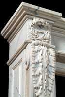 The legs of the Auguste French marble mantel have acanthus leaf and wreath details