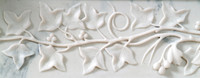 Ivy vine details on the front of the French marble mantel