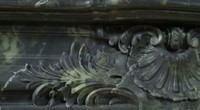 The center of this marble mantel has an acanthus leaf spray