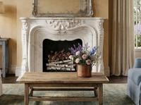 This beautifully Orleans #105 curated living space perfectly demonstrates how a highly decorative, historic marble mantel seamlessly integrates into a refined French Country or Provencal estate setting. The room balances old-world architectural grandeur with soft, rustic textures to create an atmosphere of effortless luxury.