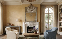 The beautifully carved white marble mantel is integrated perfectly into the breast wall, framing a warm, crackling fire set against a dark herringbone firebox.