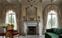 The standout feature of this mantel the Renaissance, is its two dramatic, tapered pilaster jambs, each topped with a masterfully hand-carved bust of a classical maiden (herm). These figures blend seamlessly into the architectural pillars, which gracefully taper downward to crisp block plinths.