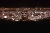 The center of the mantel is detailed