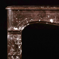 Architecturally accurate spandrels are at home on this antique marble mantel