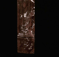 The legs of this Louis XV marble mantel are detailed