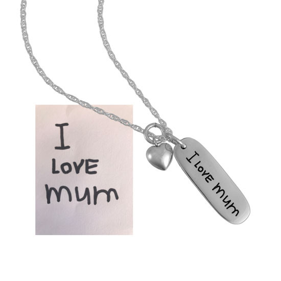 silver charm with child's handwriting, and the original writing 