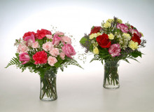 Clear gathering vases filled with colorful roses, carnations, baby breath or designers choice of unique filler