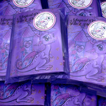 Cute cartoon dragon themed filled party bag for children’s birthday parties personalised and wrapped in coloured cello