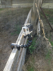 flexible gooseneck camera mount clamped on a fence 
