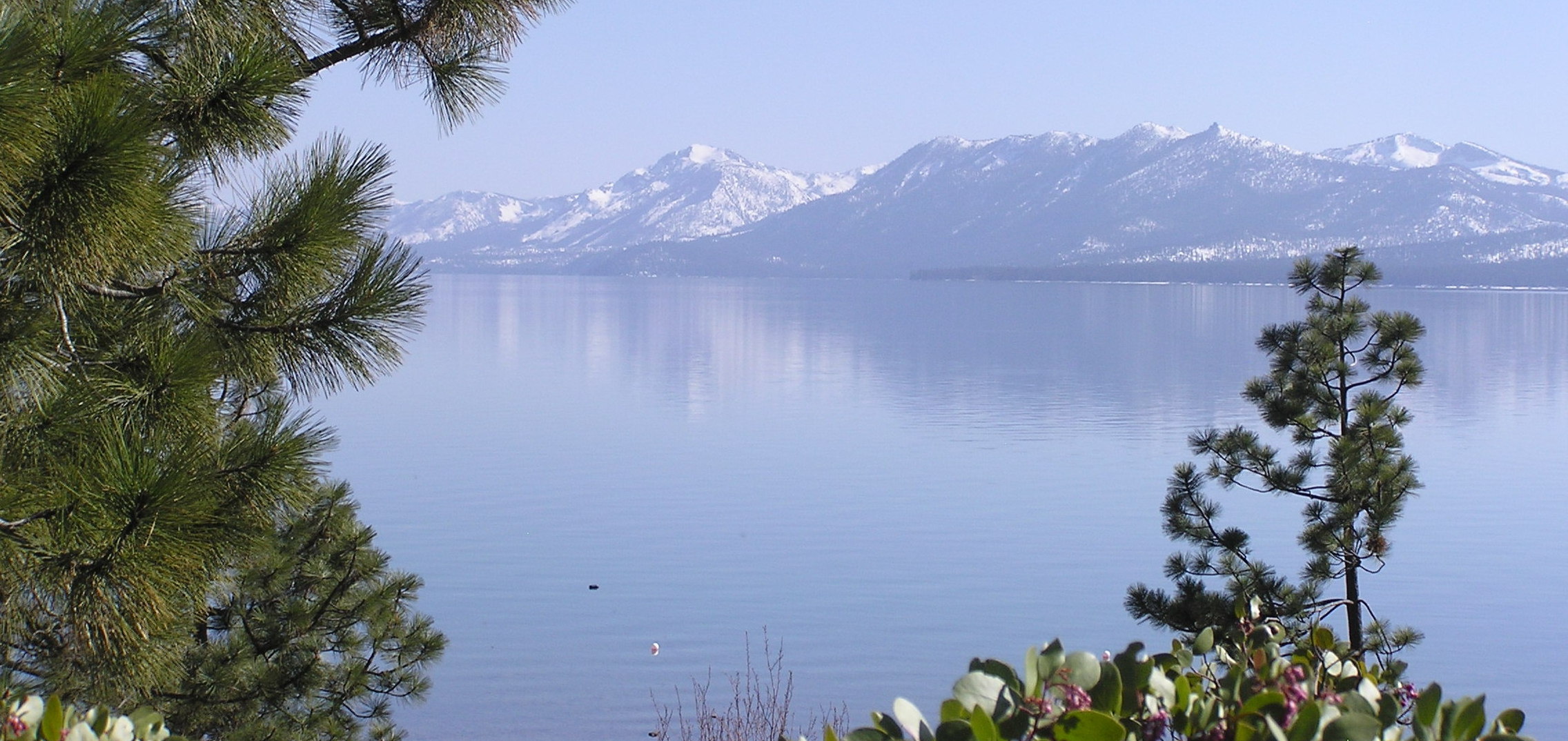 Stunning Lake Tahoe with its snow-covered Sierra Mountains reflecting in the lake.