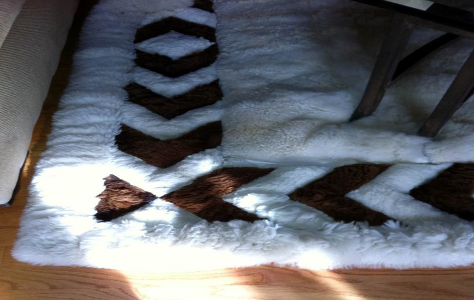 Worn Alpaca fur rug with chevron border