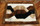 Dark Brown Border Trenza Design Alpaca Rug on Wood Floor