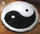 This yin-yang rug comes in two sizes and has a white border.
