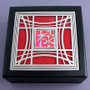 Chinese symbol prosperity with hot pink and red glass.