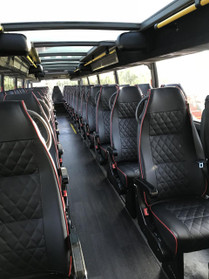 All leather seating on the second floor of the double decker bus.