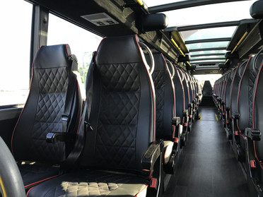 Luxury seating inside double decker bus. Glass panoramic roof.
