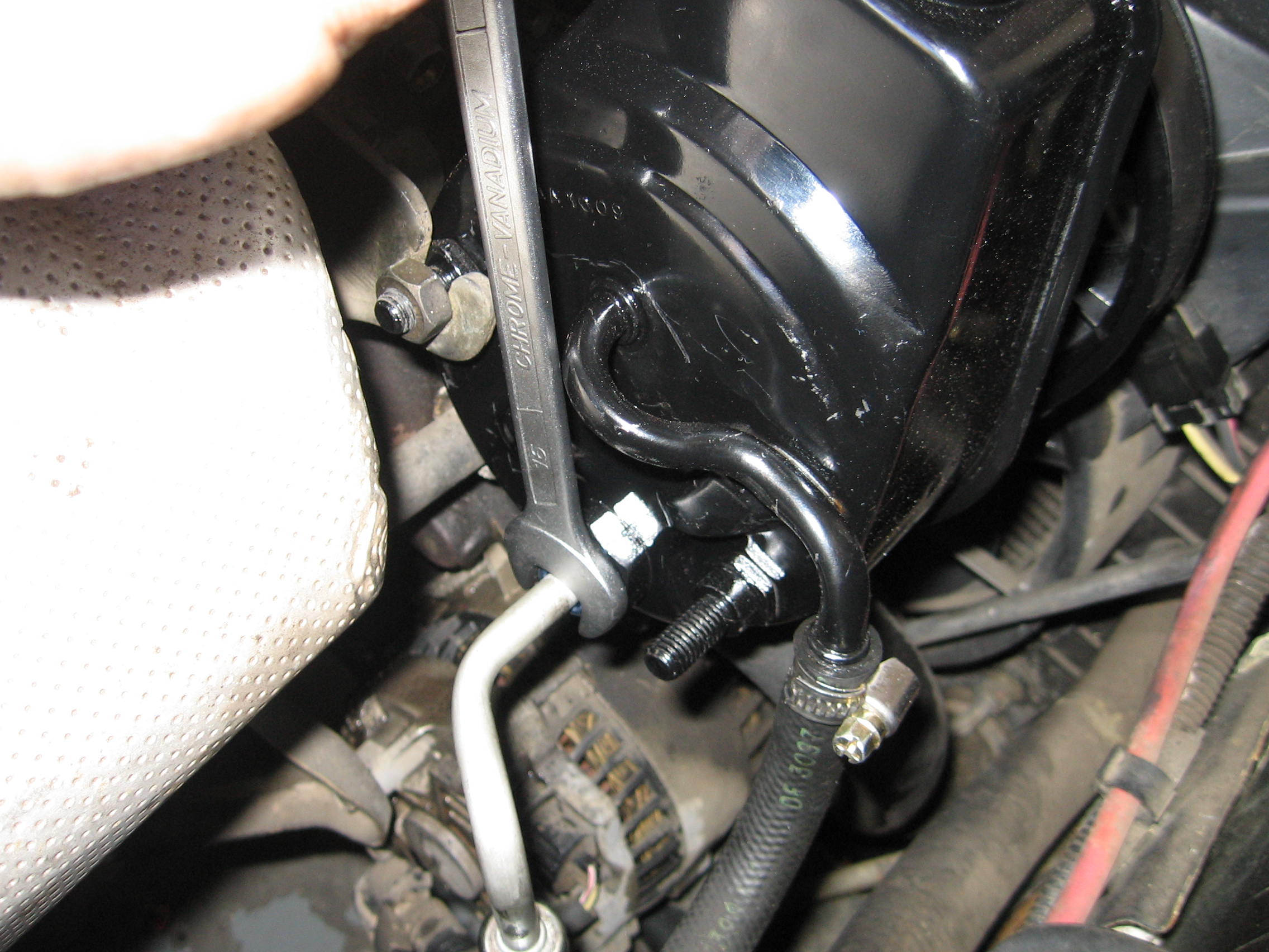 ford-au-falcon-tigitening-new-power-steering-hose-to-pump.jpg