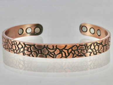 Copper bracelet with the look of pebbles in the bottom of a clear pond