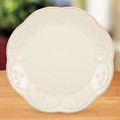 Encircling this accent plate is a parade of raised beads with a distressed tea-stain finish. A flowing beaded motif graces the plate just inside its scalloped rim.