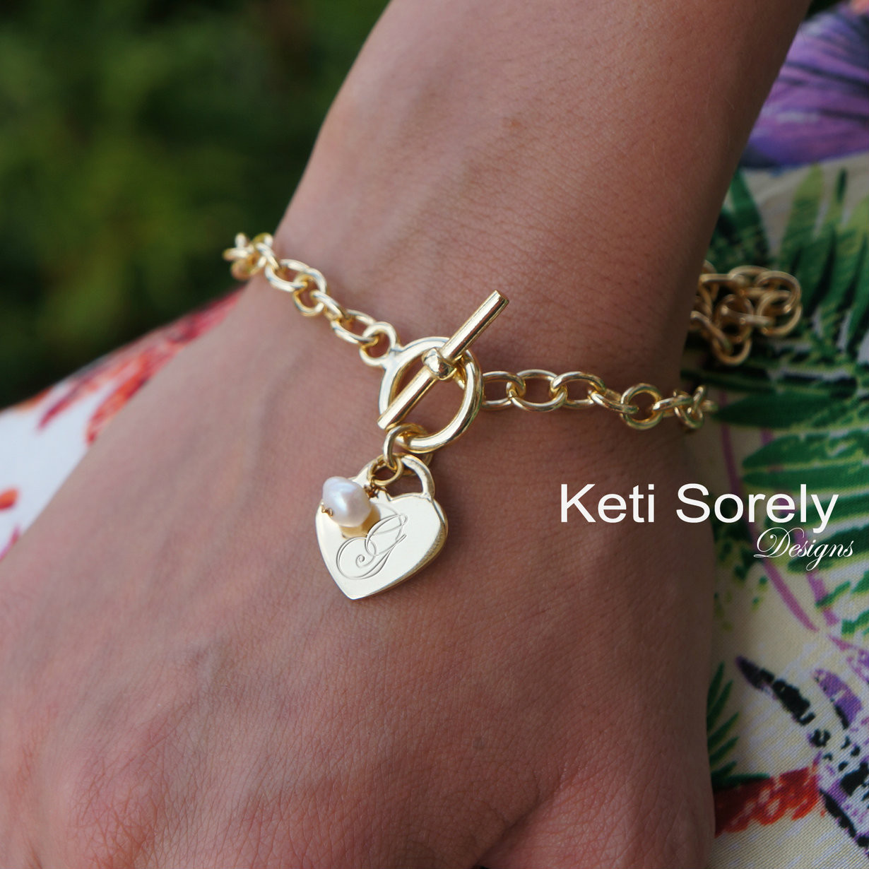 Personalized heart charm bracelet with hand engraved monogram initials and  pearl bead. Available is Sterling Silver , rose gold or yellow gold