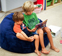 Boys sharing bean bag chair