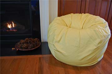 Yellow bean bag brings pastel touch to room